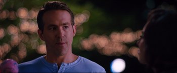 Movie still from “Free Guy” (2021), directed by Shawn Levy – A person wearing a blue shirt; Close Up shot, Over the shoulder angle