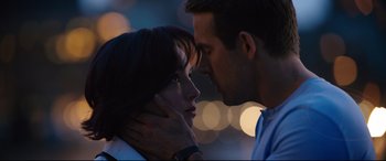 Movie still from “Free Guy” (2021), directed by Shawn Levy – A man and a woman kissing in the dark; Close Up shot, Over the shoulder angle