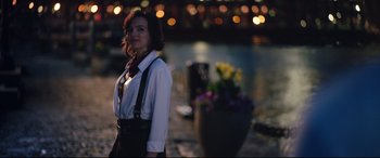 Movie still from “Free Guy” (2021), directed by Shawn Levy – A woman standing in front of a body of water; Medium shot, Over the shoulder angle