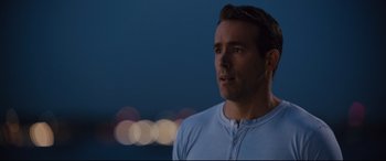 Movie still from “Free Guy” (2021), directed by Shawn Levy – A person wearing a white shirt; Close Up shot, Over the shoulder angle