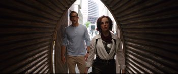 Movie still from “Free Guy” (2021), directed by Shawn Levy – A man and a woman are walking through a tunnel; Medium shot, Over the shoulder angle