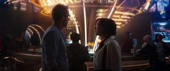 Movie still from “Free Guy” (2021), directed by Shawn Levy – A man and a woman standing next to each other; Medium shot, Over the shoulder angle