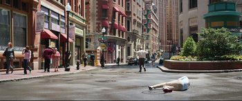 Movie still from “Free Guy” (2021), directed by Shawn Levy – A man riding a skateboard down the middle of a street; Wide shot, High angle