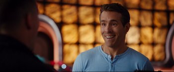 Movie still from “Free Guy” (2021), directed by Shawn Levy – A person wearing a blue shirt; Close Up shot, Over the shoulder angle