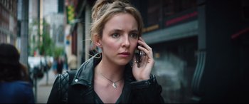Movie still from “Free Guy” (2021), directed by Shawn Levy – A woman is talking on a cell phone; Close Up shot, Low angle