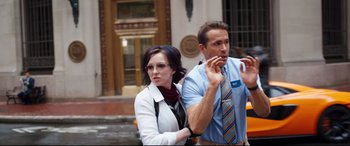 Movie still from “Free Guy” (2021), directed by Shawn Levy – A man and a woman standing next to each other on the street; Medium shot, Over the shoulder angle