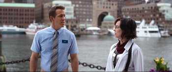 Movie still from “Free Guy” (2021), directed by Shawn Levy – A man and a woman standing next to each other near a body of water; Medium shot, Over the shoulder angle