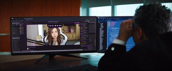 Movie still from “Free Guy” (2021), directed by Shawn Levy – A woman sitting in front of a computer monitor; Extreme Close Up shot, Over the shoulder angle