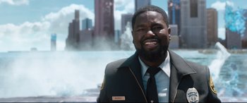 Movie still from “Free Guy” (2021), directed by Shawn Levy – A man wearing a suit and tie smiling for the camera; Close Up shot, High angle