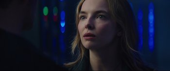 Movie still from “Free Guy” (2021), directed by Shawn Levy – A beautiful young lady looking off into the distance; Close Up shot, Over the shoulder angle