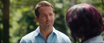 Movie still from “Free Guy” (2021), directed by Shawn Levy – A person wearing a blue shirt; Close Up shot, Over the shoulder angle