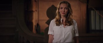 Movie still from “Free Guy” (2021), directed by Shawn Levy – A woman in a white shirt standing in a room; Medium shot, Over the shoulder angle