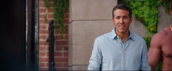 Movie still from “Free Guy” (2021), directed by Shawn Levy – A person wearing a blue shirt; Medium shot, Over the shoulder angle