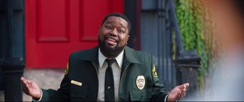 Movie still from “Free Guy” (2021), directed by Shawn Levy – A man wearing a green jacket and a white shirt; Medium shot, Over the shoulder angle