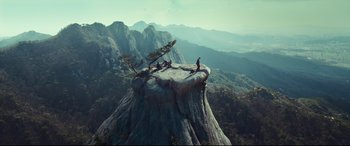 Movie still from “Decision to Leave” (2022), directed by Park Chan-wook – A person sitting on top of a rock on top of a mountain; Extreme Wide shot, High angle