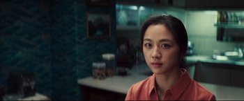 Movie still from “Decision to Leave” (2022), directed by Park Chan-wook – A woman in a room with a mirror in the background; Close Up shot, Over the shoulder angle
