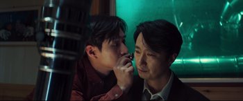 Movie still from “Decision to Leave” (2022), directed by Park Chan-wook – Two men are looking at each other in the mirror; Close Up shot, Over the shoulder angle