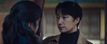 Movie still from “Decision to Leave” (2022), directed by Park Chan-wook – A man and a woman on a bus in the rain; Close Up shot, Over the shoulder angle