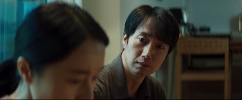 Movie still from “Decision to Leave” (2022), directed by Park Chan-wook – A person sitting in front of a mirror; Close Up shot, Over the shoulder angle