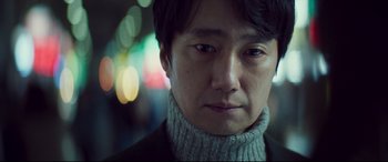 Movie still from “Decision to Leave” (2022), directed by Park Chan-wook – A person wearing a sweater; Close Up shot, Low angle
