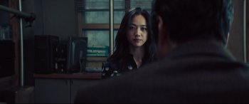 Movie still from “Decision to Leave” (2022), directed by Park Chan-wook – A woman is looking at a man in front of a window; Close Up shot, Over the shoulder angle