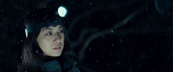 Movie still from “Decision to Leave” (2022), directed by Park Chan-wook – A person with a headlamp in the dark; Close Up shot, Low angle