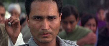 Movie still from “Gandhi” (1982), directed by Richard Attenborough – A man's face in front of another man; Close Up shot, Low angle