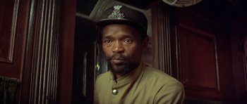 Movie still from “Gandhi” (1982), directed by Richard Attenborough – A man with a beard wearing a hat; Close Up shot, Low angle