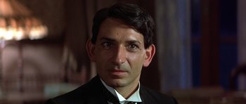 Movie still from “Gandhi” (1982), directed by Richard Attenborough – A person wearing a suit and tie; Close Up shot, Low angle