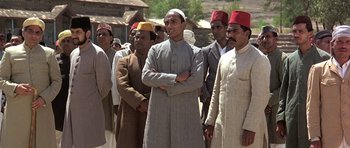 Movie still from “Gandhi” (1982), directed by Richard Attenborough – A group of men standing next to each other; Medium shot, Low angle