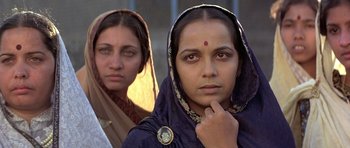 Movie still from “Gandhi” (1982), directed by Richard Attenborough – Two indian women standing next to each other; Close Up shot, Low angle