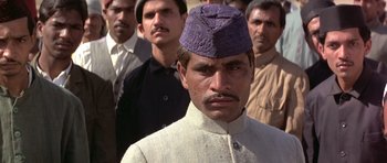 Movie still from “Gandhi” (1982), directed by Richard Attenborough – A group of men standing next to each other; Close Up shot, Low angle