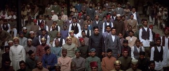 Movie still from “Gandhi” (1982), directed by Richard Attenborough – A large group of men in suits and hats; Wide shot, High angle