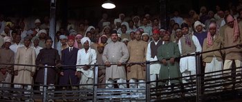 Movie still from “Gandhi” (1982), directed by Richard Attenborough – A large group of men standing next to each other; Wide shot, Low angle