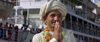 Movie still from “Gandhi” (1982), directed by Richard Attenborough – A man in a white turban is praying; Close Up shot, Low angle