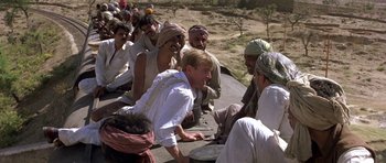 Movie still from “Gandhi” (1982), directed by Richard Attenborough – A group of people sitting on a train; Medium shot, High angle