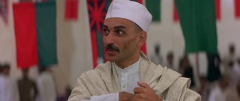Movie still from “Gandhi” (1982), directed by Richard Attenborough – A man in a white hat and a white robe; Close Up shot, Low angle