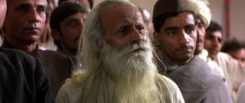 Movie still from “Gandhi” (1982), directed by Richard Attenborough – An old man with long white hair and a beard; Close Up shot, Low angle