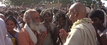 Movie still from “Gandhi” (1982), directed by Richard Attenborough – A group of people standing around each other; Medium shot, Low angle