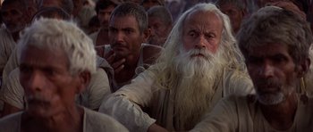 Movie still from “Gandhi” (1982), directed by Richard Attenborough – A group of men sitting next to each other; Close Up shot, High angle