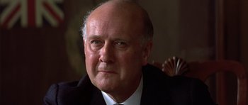 Movie still from “Gandhi” (1982), directed by Richard Attenborough – An older man wearing a suit and tie; Close Up shot, Low angle