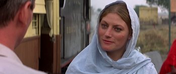 Movie still from “Gandhi” (1982), directed by Richard Attenborough – A woman wearing a white scarf and a blue veil; Close Up shot, Over the shoulder angle