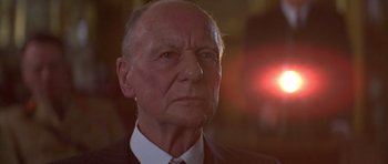 Movie still from “Gandhi” (1982), directed by Richard Attenborough – An older man wearing a suit and tie; Close Up shot, Low angle