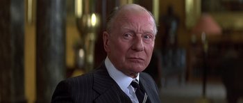 Movie still from “Gandhi” (1982), directed by Richard Attenborough – An older man wearing a suit and tie; Close Up shot, Low angle