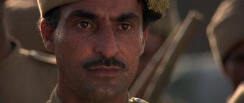 Movie still from “Gandhi” (1982), directed by Richard Attenborough – A person wearing a hat; Close Up shot, Low angle