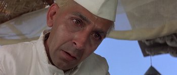 Movie still from “Gandhi” (1982), directed by Richard Attenborough – A person wearing a white hat; Close Up shot, Low angle