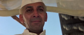 Movie still from “Gandhi” (1982), directed by Richard Attenborough – A person wearing a white hat; Close Up shot, Low angle