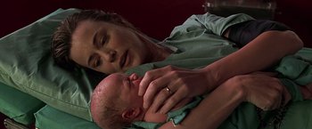 Movie still from “Gattaca” (1997), directed by Andrew Niccol – A woman is holding a baby in her arms; Close Up shot, Over the shoulder angle