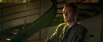 Movie still from “Gattaca” (1997), directed by Andrew Niccol – A man standing in front of a spiral stair case; Close Up shot, Low angle