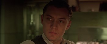 Movie still from “Gattaca” (1997), directed by Andrew Niccol – A person wearing a suit and tie; Close Up shot, Low angle